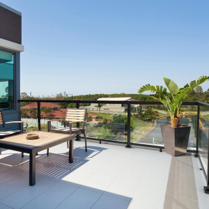 Large balcony near the beach, Peak Aluminium Balustrade in black with large glass panels installed on a the deck.