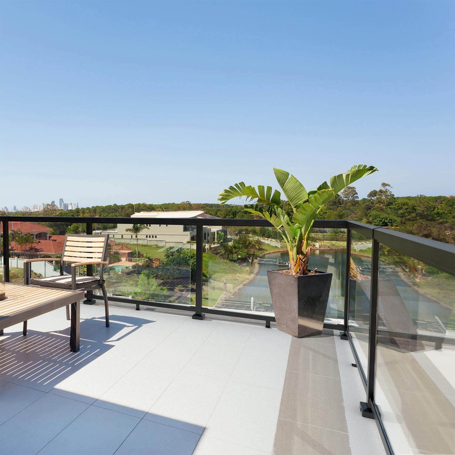 Peak Aluminium Balustrade in black with glass panels installed on a balcony.