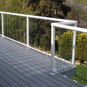 Grey composite balcony deck overlooking a garden. White Peak Aluminium Balustrade with sectional glass panels installed.