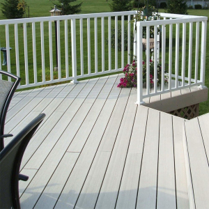 White Peak Aluminium Balustrade with wide balusters on a grey composite deck overlooking a grassy garden.